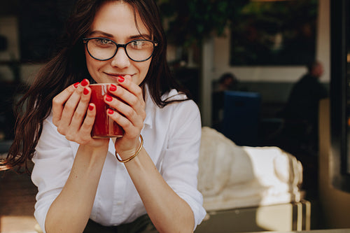 Beautiful woman with a cup of coffee at cafe