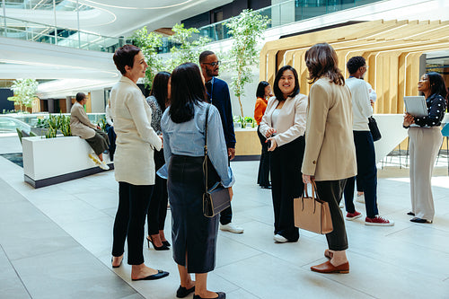 Professional networking event in modern corporate lobby setting