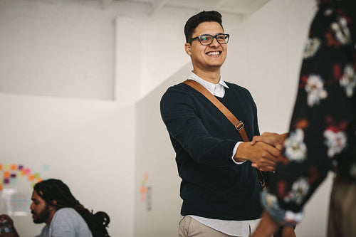 Businessman greeting a client shaking hands