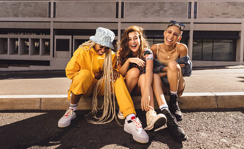 Group of female friends laughing cheerfully in the city