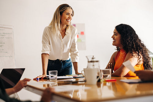 Happy businesswomen having a meeting in a creative office