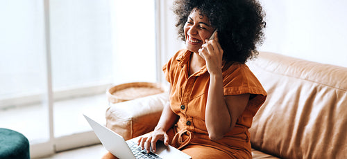 Businesswoman smiling happily while speaking on the phone
