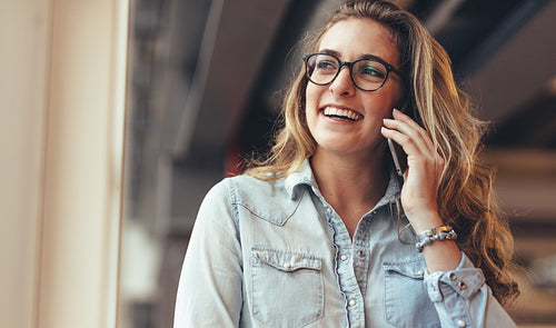 Portrait of a smiling woman talking on mobile phone