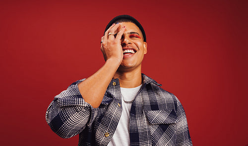 Stylish young man smiling in a studio