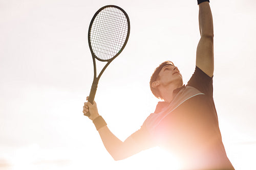 Professional tennis player making a serve