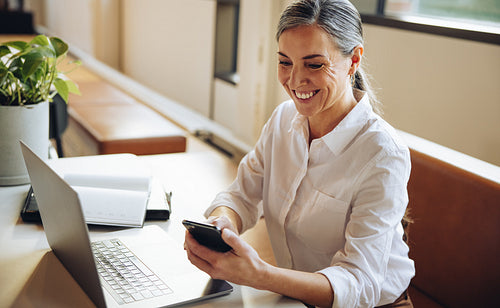 Mature businesswoman using mobile phone