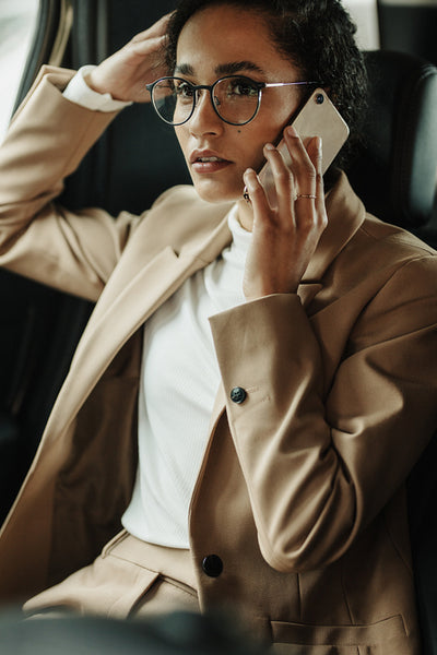 Businesswoman traveling by and talking on phone