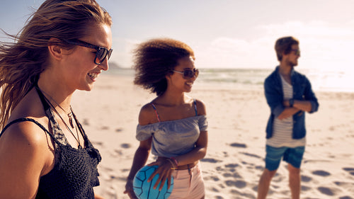 Friends playing with volleyball on the beach