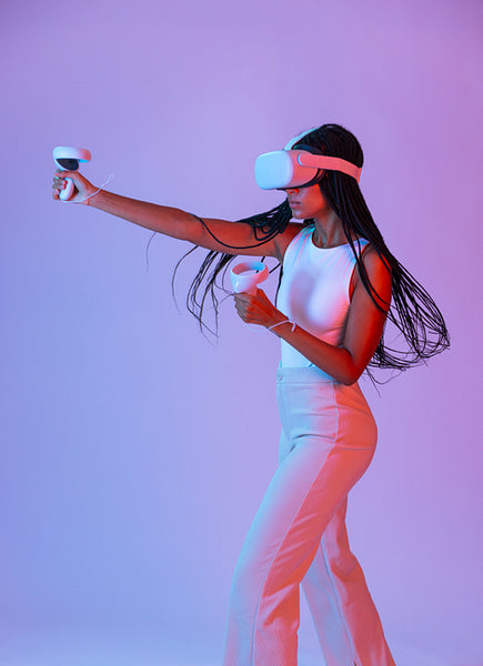 Female gamer playing a virtual reality game in neon light