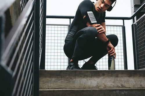 Fitness man resting after physical training outdoors