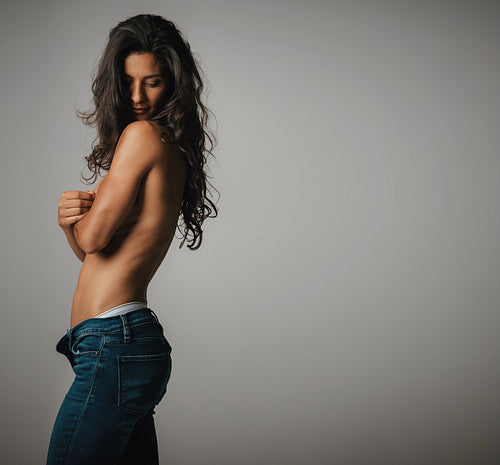 Sexy woman in suggestive partially nude pose