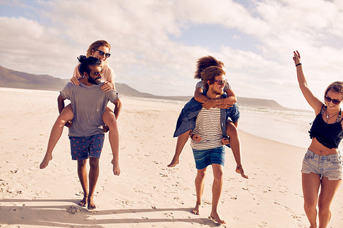 Happy young couple enjoying summer vacation on the beach