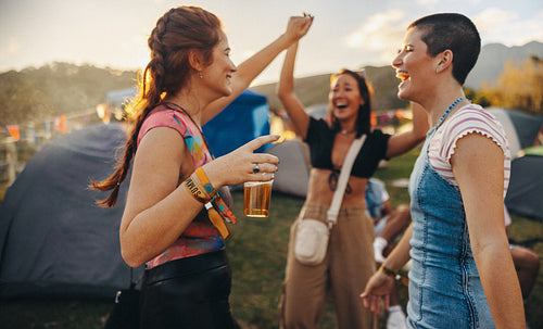 Fun moments unfold as three female friends unite in laughter, dance, and celebration at the summer music festival