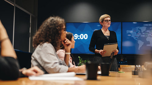 Businesswoman addressing boardroom meeting