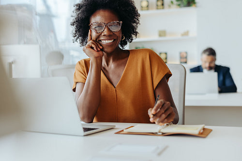 Happy businesswoman using smartphone at modern office