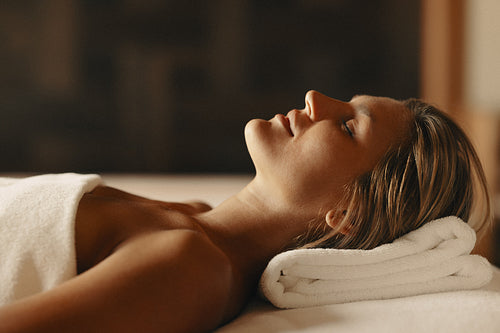 Woman enjoying a relaxing facial treatment at a luxurious spa salon