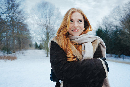 Freckled freckles face winter snow in a coat