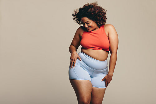 Woman celebrating her body positivity through dance in a studio
