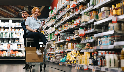 Young workers having fun packing goods