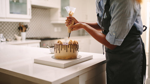Pastry chef decorating a cake