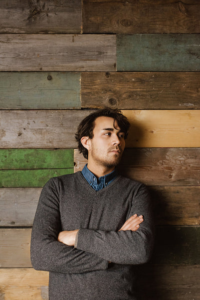 Handsome young business man against a wooden wall