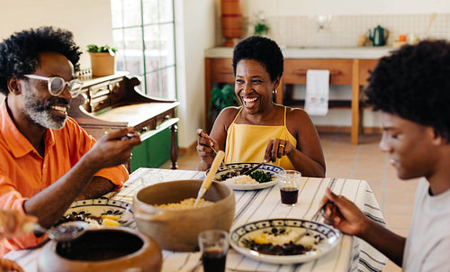 Happy Brazilian family dining for a traditional meal together at home
