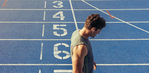 Sprinter standing on running track