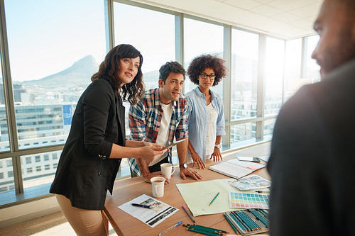 Team brainstorming over new designs in office