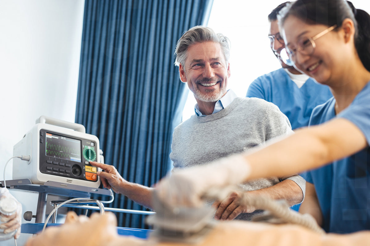 Happy doctor teaching students in simulation-based training – Jacob ...