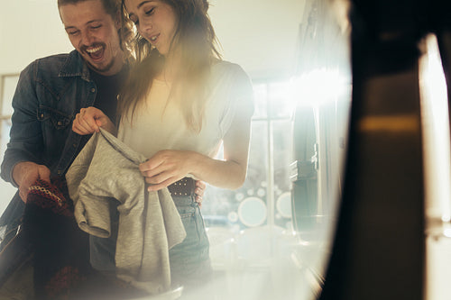 Happy couple doing laundry together