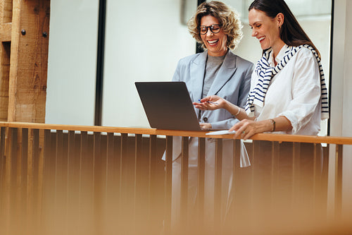 Professional women connect with their team on a video call