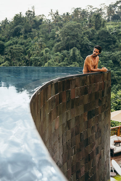 Young man relaxing in pool at holiday resort