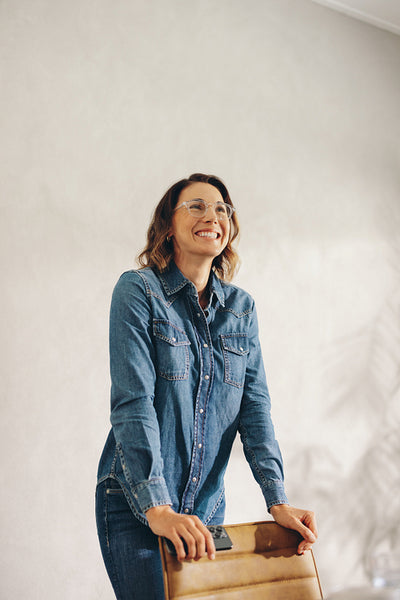 Happy business woman dressed in casual denim at work