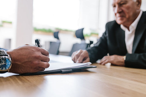 Business people signing contract papers