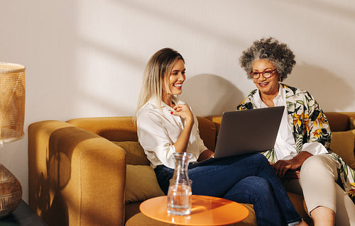 Cheerful businesswomen having a video call in an office lobby