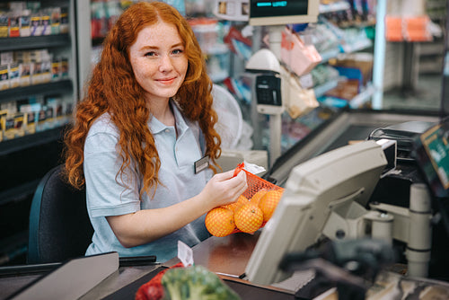 Cashier on checkout in supermarket