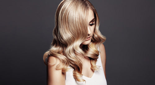 Elegant woman with shiny wavy blond hair
