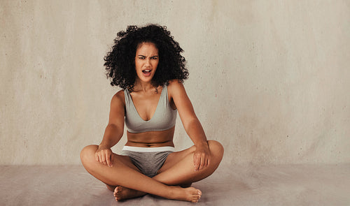 Portrait of a  confident woman posing in her natural body