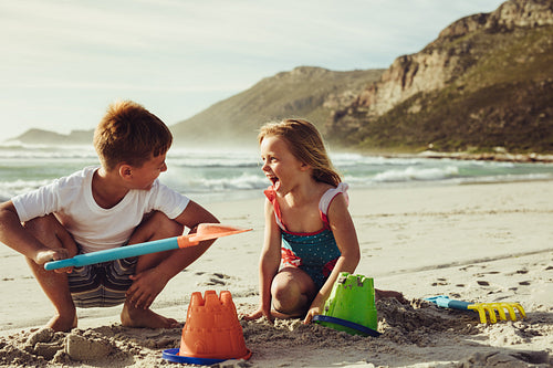 Kids building sandcastle on the beach