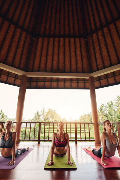 Three beautiful young women doing yoga