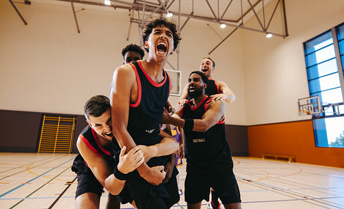Group of basketball players celebrating a big win