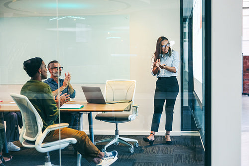 Group of colleagues applauding their success in a boardroom
