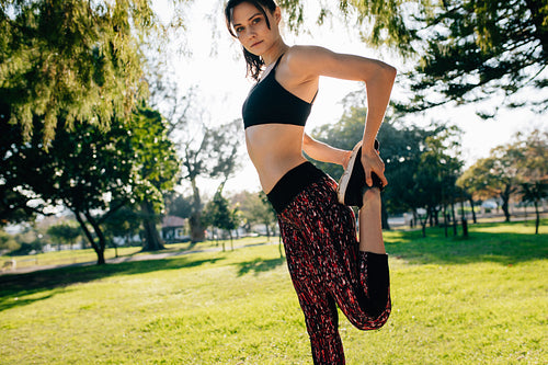 Fit young woman stretching legs at he park