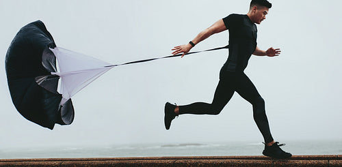 Runner working out using resistance parachute 
