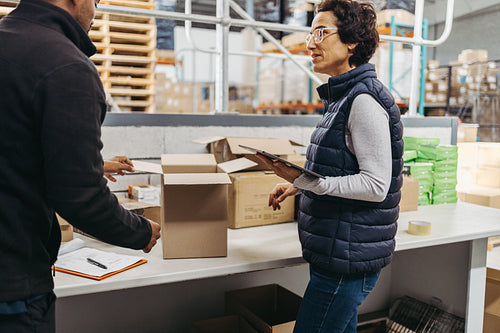 Warehouse manager and trainee fulfilling online orders