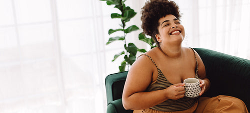 Happy woman with coffee mug at home