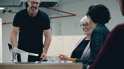 Corporate professionals clapping hands after a productive meeting