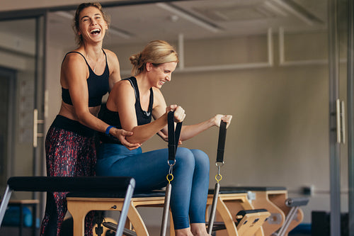 Women having fun while doing pilates workout 