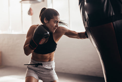 Female boxer training inside a boxing ring
