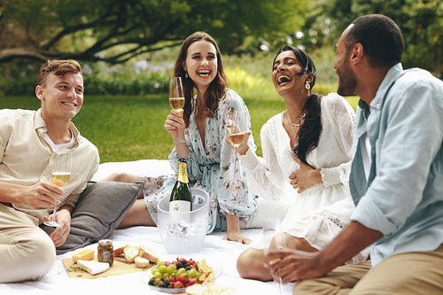 Young people enjoying a deluxe picnic at the park